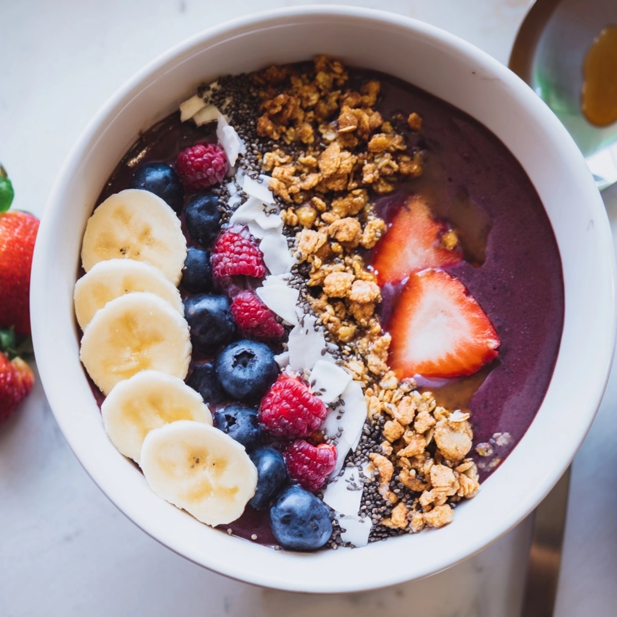 A vibrant Acai Bowl: Sweet frozen fruit, crunchy granola, and drizzled honey create a delightful texture.