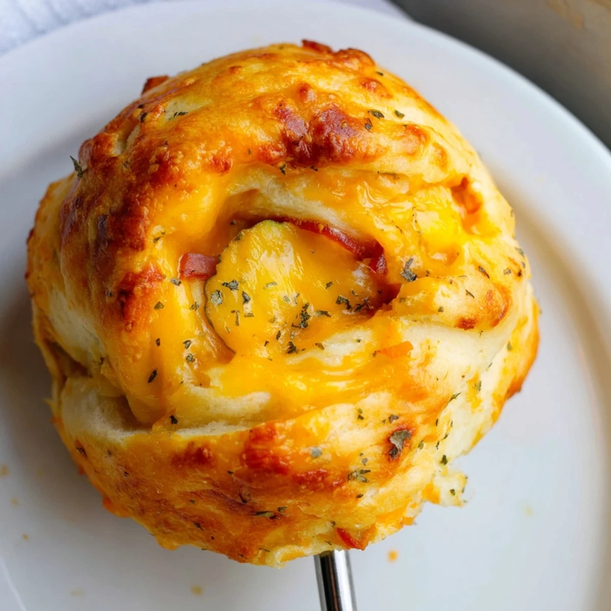 Flaky Cheesy Pickle Ham Biscuit Pops served warm and fresh from the oven.  