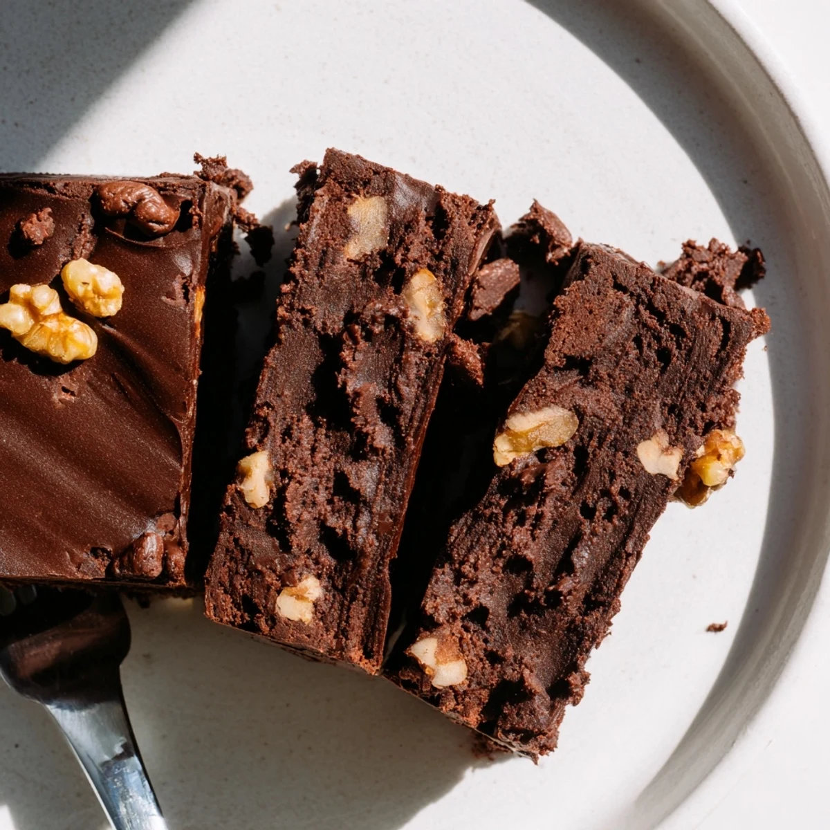 Delicious fudgy zero-waste brownies topped with nuts and served warm with ice cream.  