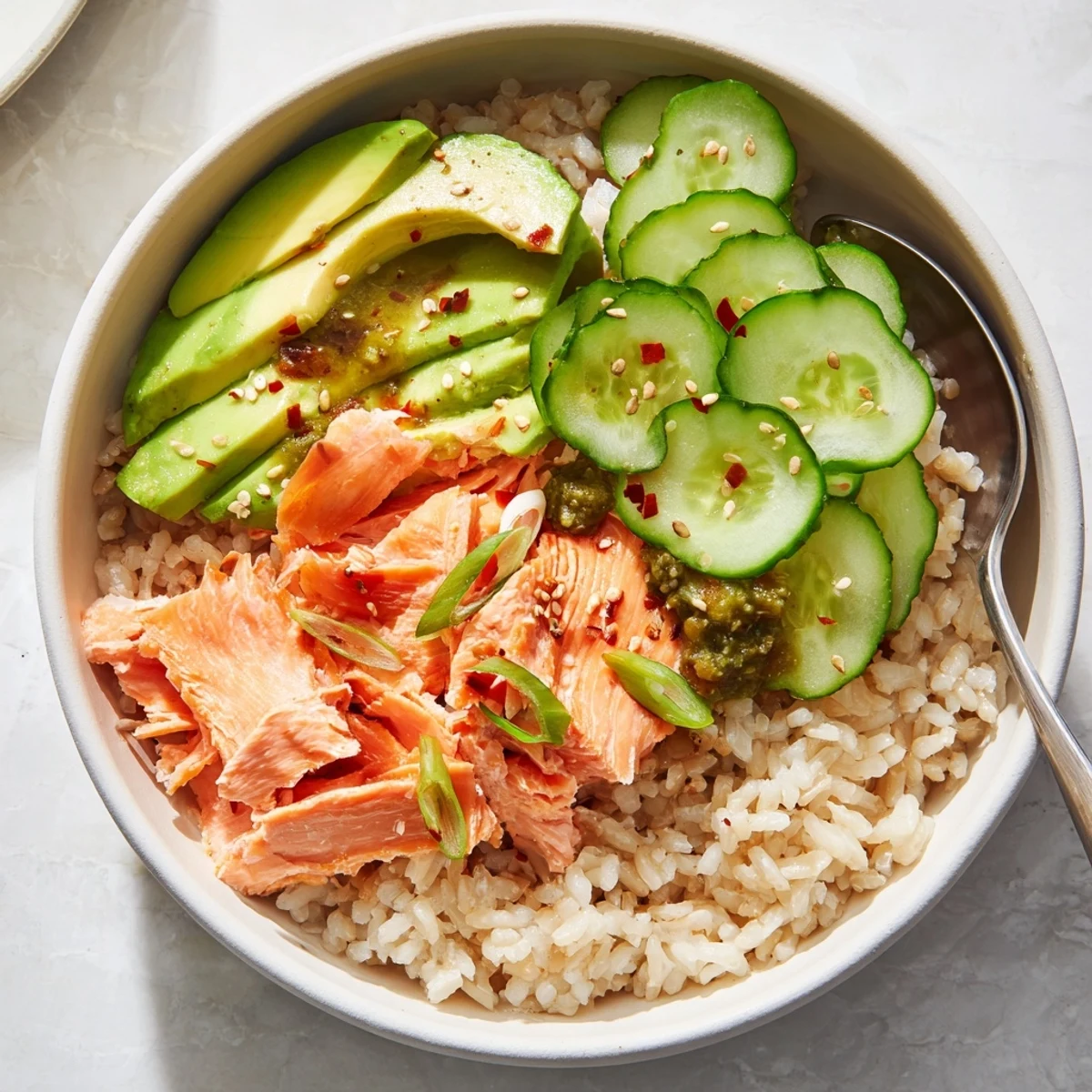 Delicious Leftover Salmon & Rice Bowl with steamed rice, salmon, and colorful veggies.
