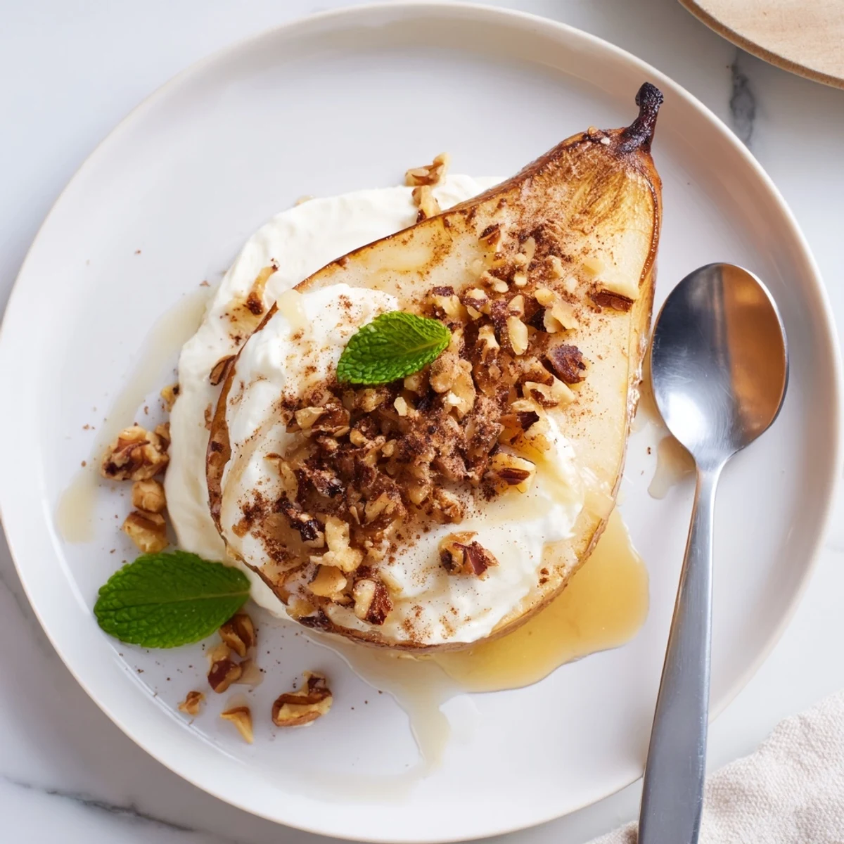 Warm, tender roasted pears with cinnamon, walnuts, and Greek yogurt—a healthy dessert.