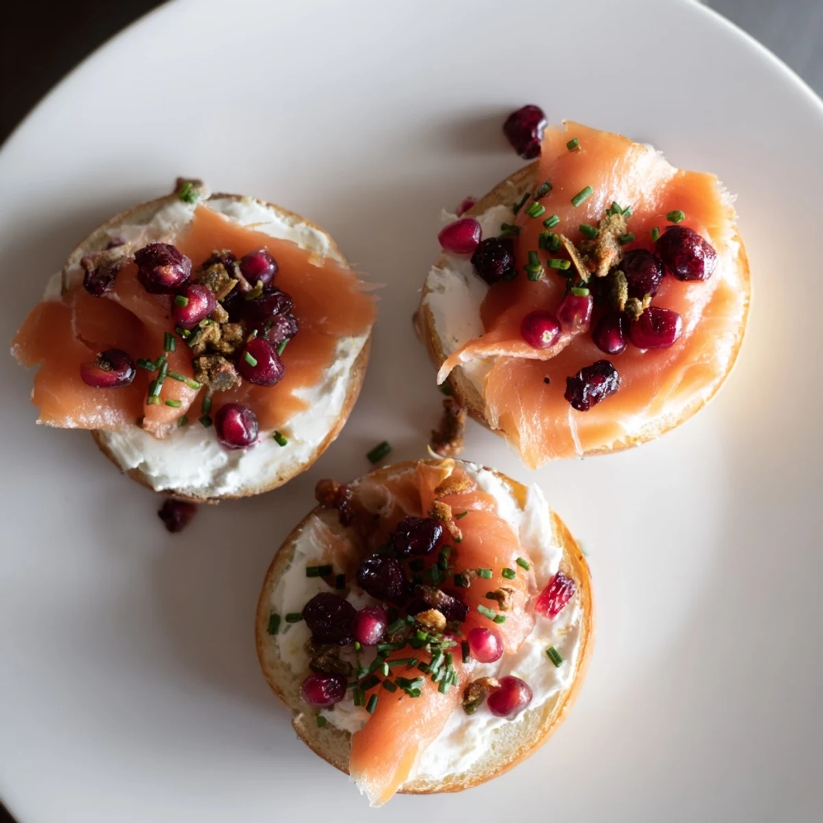 Festive Cranberry Sleigh Bagel Board with vibrant red cranberries, smoked salmon, and fresh dill, perfect for brunch.