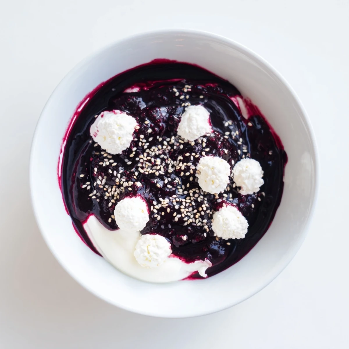 Imagine a stunning Galaxy Spiral: cool yogurt, swirled berry jam, seed stars, with goat cheese.