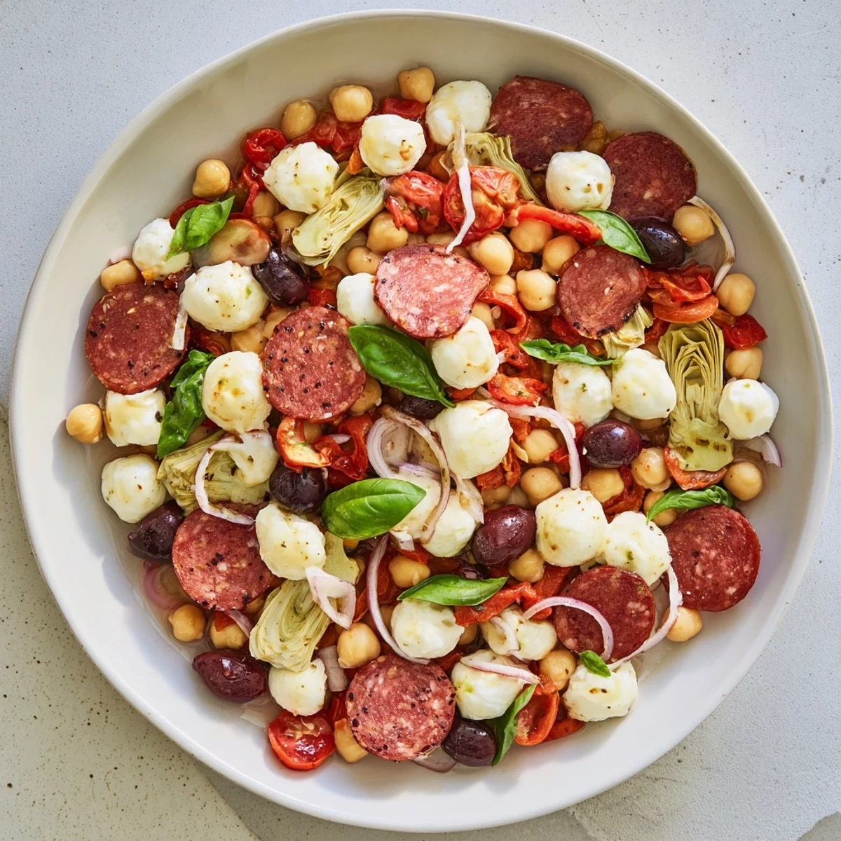 A close-up view of the Antipasto Chickpea Salad, showing plump chickpeas and colorful vegetables, ready to eat.