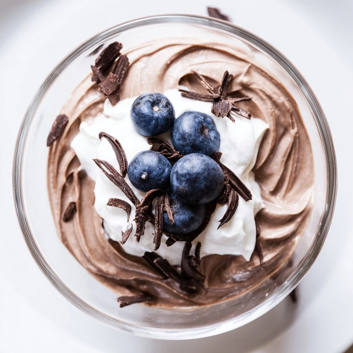 Rich and dark: a bowl of homemade avocado chocolate pudding, perfect as a quick vegan dessert.