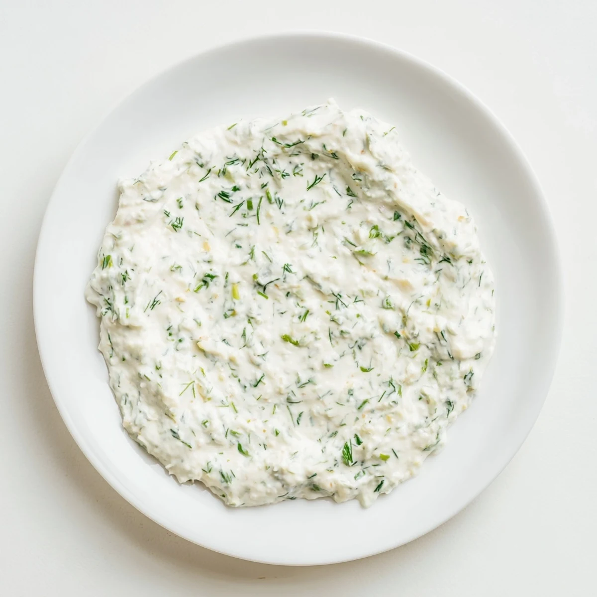 A bowl of creamy Greek Yogurt Ranch Dip, perfect for dipping fresh vegetables.
