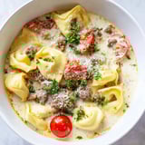 Close-up of a rich Tortellini Beef Soup, showcasing plump tortellini and beef in a flavorful tomato broth.