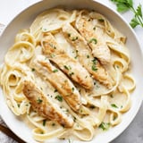 Delicious Skillet Chicken Alfredo features golden chicken nestled in a rich, Parmesan-infused sauce with pasta.