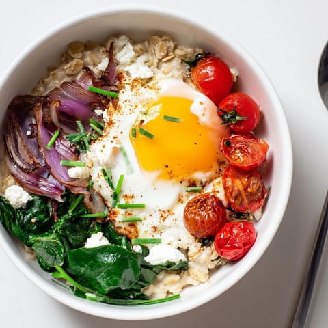 Elevated savory oatmeal bowl, a warm and healthy dish, sprinkled with feta and chives.