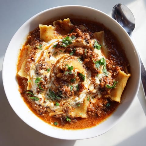 Hearty bowl of Lasagne Soup with Caramelized Onion Swirl, perfect for cozy dinners.  