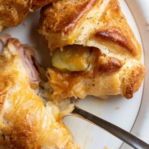 Savory Cheesy Pickle Ham Biscuit Pops featuring tangy pickles and melting cheese.  