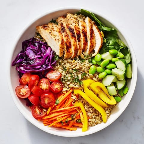 Delicious Healthy Meal-Prep Bowls filled with grilled chicken, fresh vegetables, and zesty dressing.  