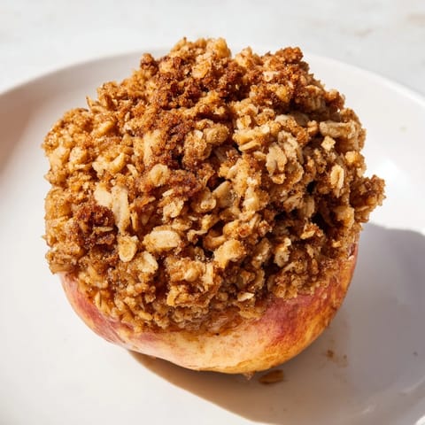 A close-up of delicious Baked Apples with Oat-Nut Crumble, showcasing the tender apple and crumble topping.