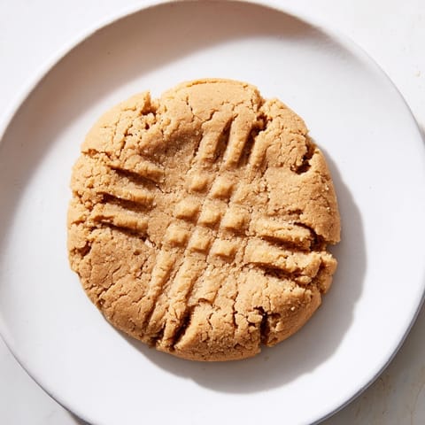 Warm, freshly baked Flourless Peanut Butter Cookies, with a classic crisscross pattern ready to serve.