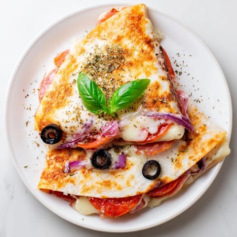 Golden brown tortilla pizza wrap sliced open, showcasing melted cheese and fresh toppings.