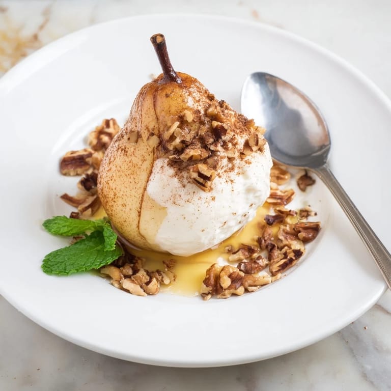 Golden-brown roasted pears, topped with walnuts and creamy Greek yogurt—the perfect cinnamon-infused treat.