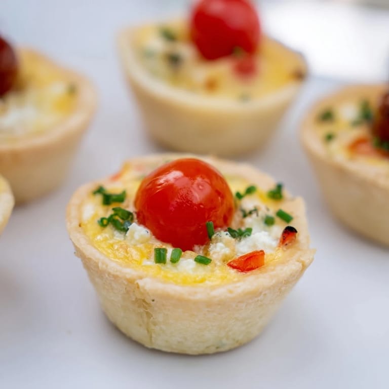Enjoy the delicate floral presentation of these scrumptious Couronne Florale Mini Quiches, ideal for sharing.