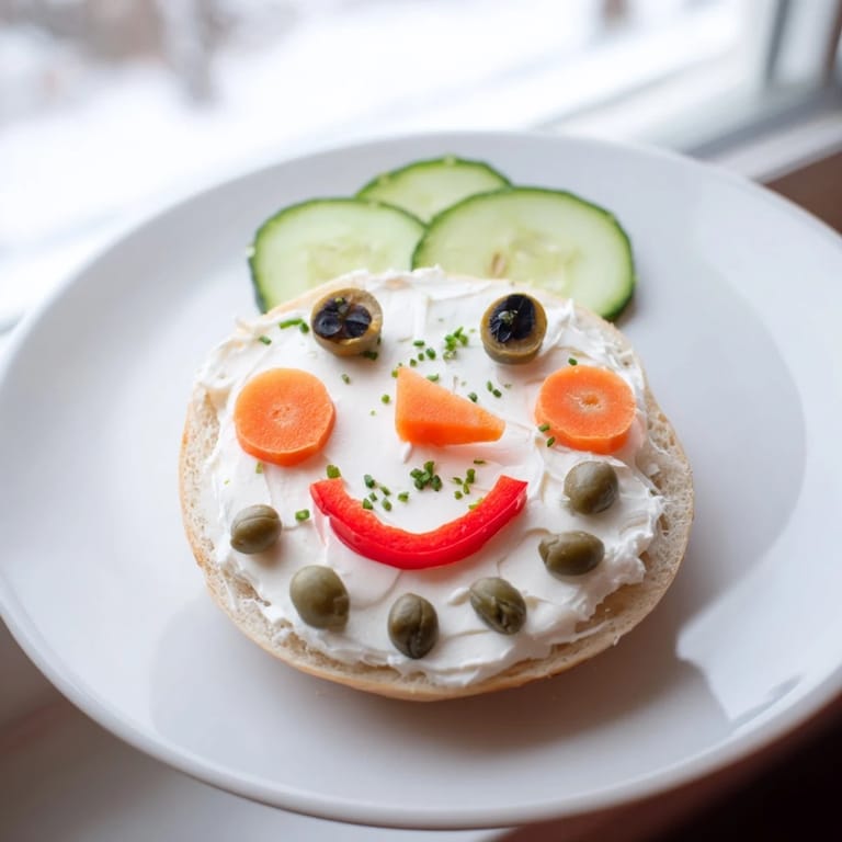 Delicious, decorated Snowman Mini Bagel Sandwiches, showcasing a close-up of the joyful, edible, winter-themed faces.