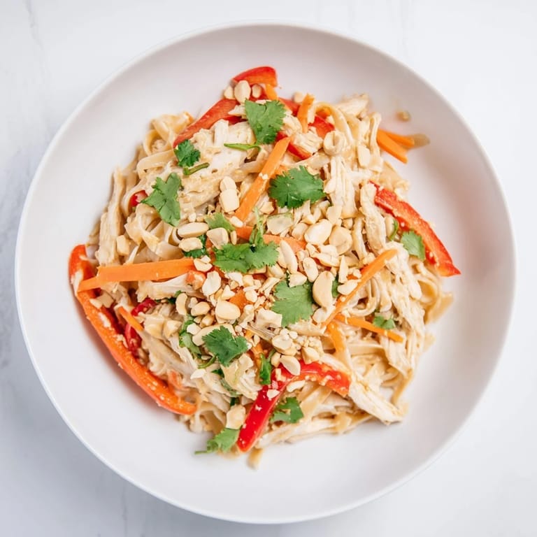 Fresh, vibrant Thai-Inspired Peanut Chicken Pasta salad showcasing the tender chicken and crunchy toppings.
