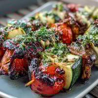 Vibrant grilled vegetable skewers with chimichurri sauce, perfect for summer barbecues and outdoor dining.  